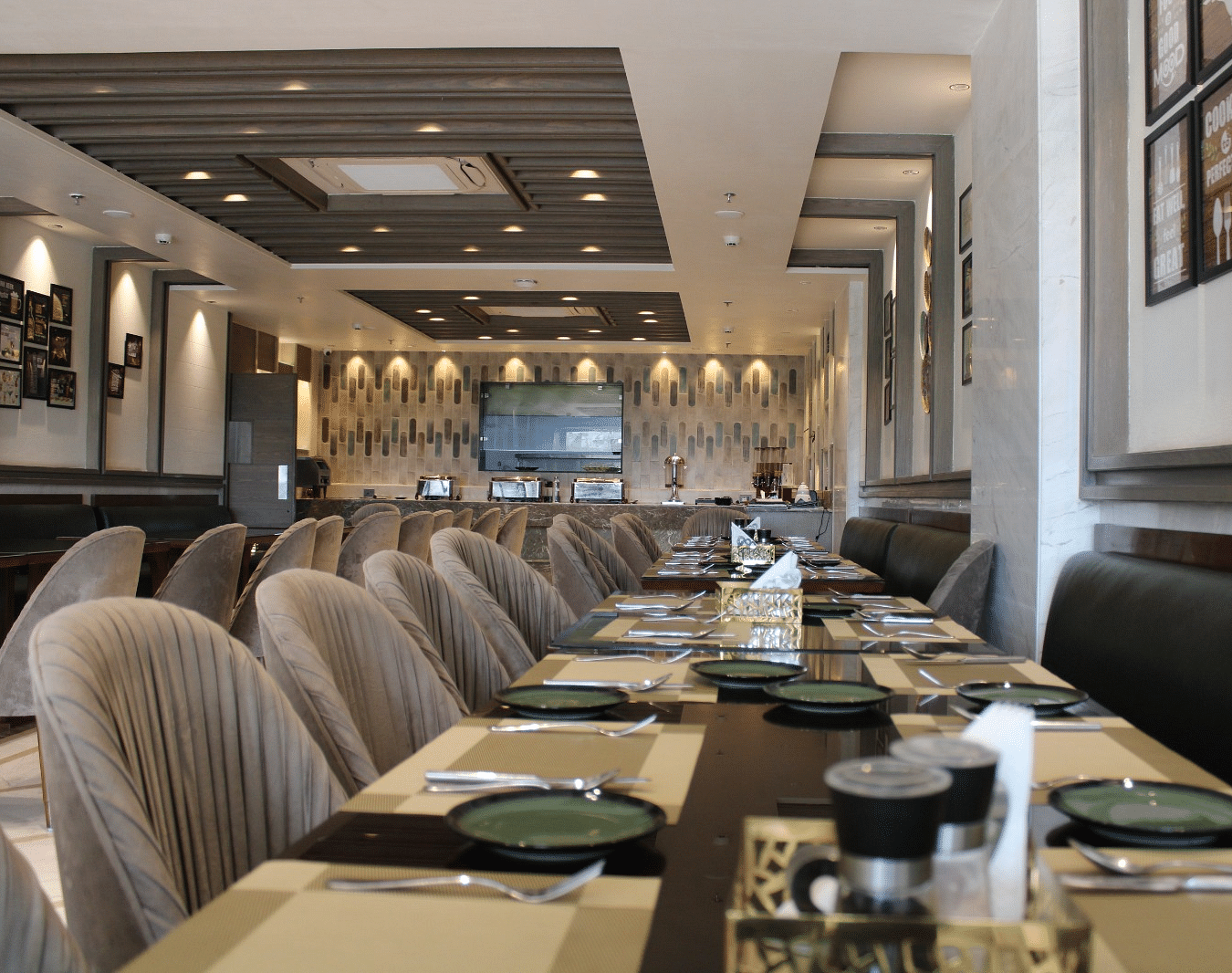 A well-arranged dining space featuring tables with chairs and neatly set cutlery at BluSalzz Residence, Amritsar